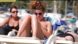 Sexy Nudist Babe Topless showing tits on nude beach 911