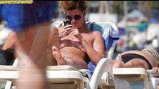 Sexy Nudist Babe Topless showing tits on nude beach 911