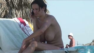 Sexy Nudist Babe Topless showing tits on nude beach 1036