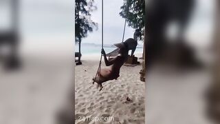 NinaCola3 wearing T-back playing the swing on the beach