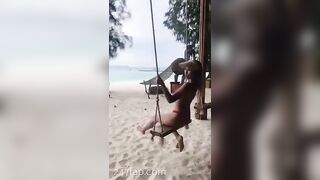 NinaCola3 wearing T-back playing the swing on the beach