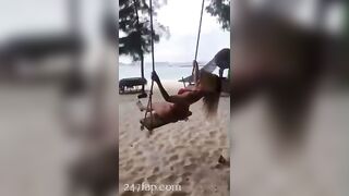 NinaCola3 wearing T-back playing the swing on the beach