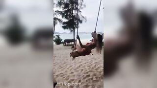 NinaCola3 wearing T-back playing the swing on the beach