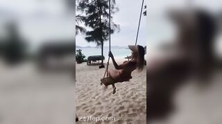 NinaCola3 wearing T-back playing the swing on the beach