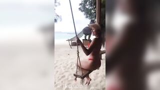 NinaCola3 wearing T-back playing the swing on the beach